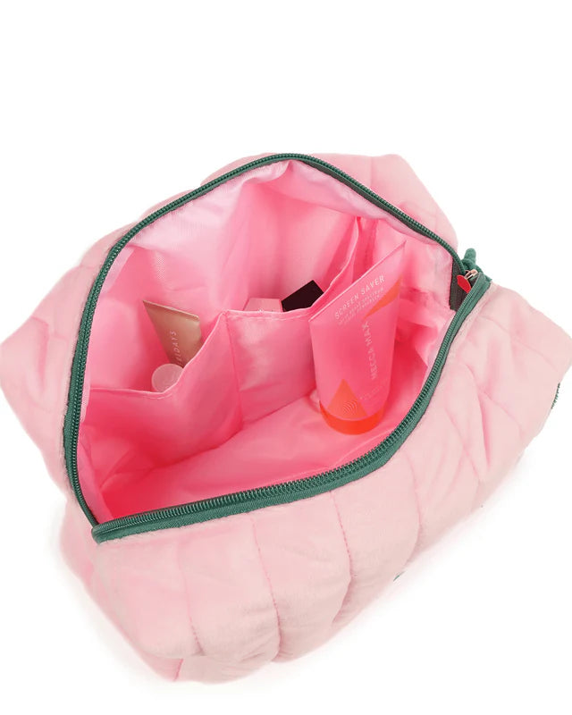 Pink makeup bag with green zipper on a white background