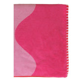 Pink and white patterned towel on a white background