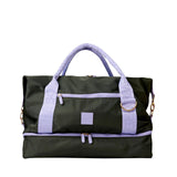 Black duffel bag with purple straps and accents on a white background