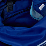 Close-up of a blue jacket with a brand label and zipper details.