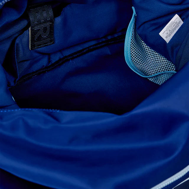 Close-up of a blue jacket with a brand label and zipper details.