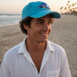 Man wearing a blue cap and white shirt on a beach
