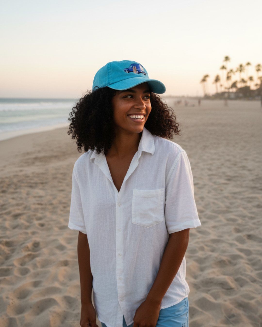 Woman wearing a blue cap and white shirt on a beach