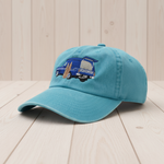 Blue cap with embroidered design on a light wooden surface