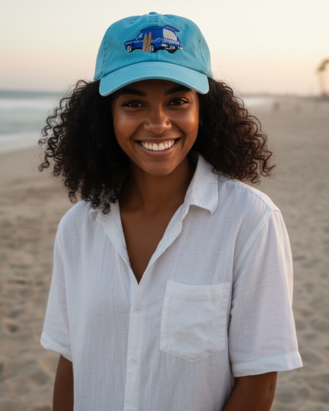 Woman wearing a blue cap and white shirt on a beach