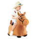 Child in cowboy hat riding a toy horse