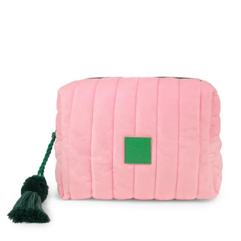 Pink quilted pouch with a green tag and tassel on a white background