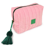 Pink pouch with a green tassel on a white background