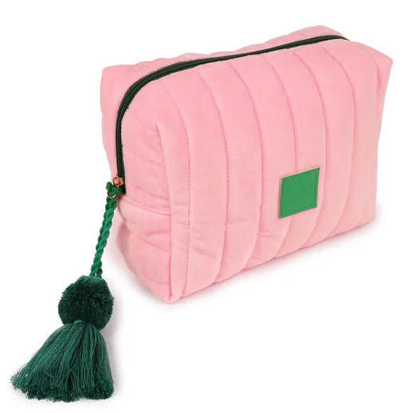 Pink pouch with a green tassel on a white background