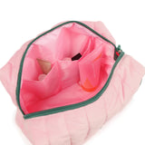 Pink makeup bag with green zipper on a white background