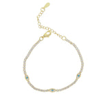 Gold bracelet with gemstones on a white background