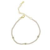 Gold bracelet with gemstones on a white background