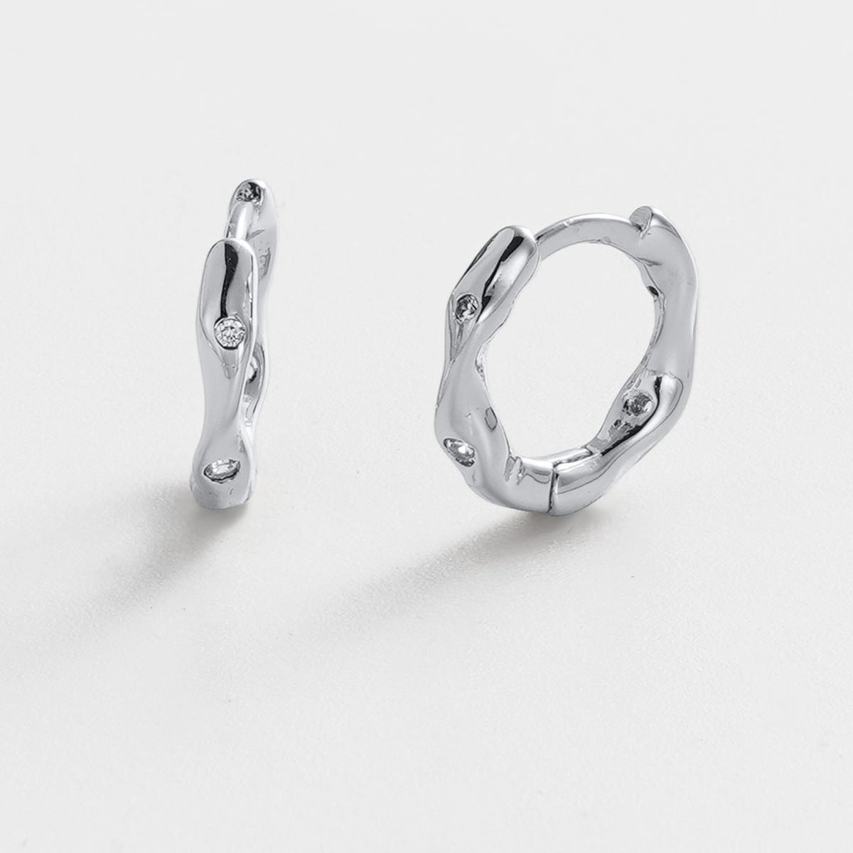 Pair of silver hoop earrings on a white background