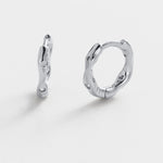Pair of silver hoop earrings on a white background