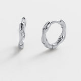 Pair of silver hoop earrings on a white background