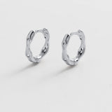 Pair of silver hoop earrings on a light gray background
