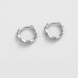 Pair of silver hoop earrings on a light gray background