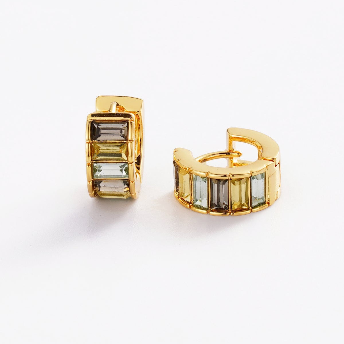 Gold hoop earrings with rectangular gemstones on a white background