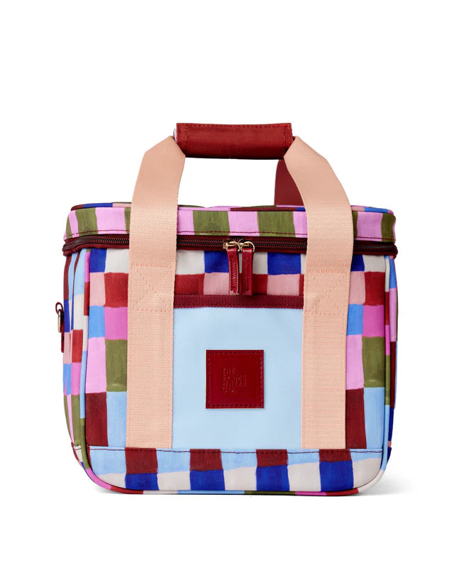 Colorful checkered bag with pink handles on a white background