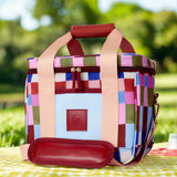Colorful checkered bag with a red handle on a white background