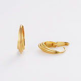 Gold hoop earrings on a light gray background