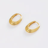 Pair of gold hoop earrings on a light gray background