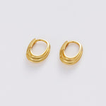 A pair of gold-toned, multi-strand hoop earrings on a clean, light gray background.