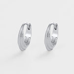 Pair of silver hoop earrings on a light gray background