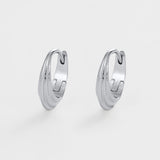 Pair of silver hoop earrings on a light gray background
