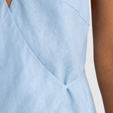Light blue sleeveless top with a V-neckline on a neutral background