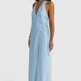 Woman wearing a light blue jumpsuit on a white background