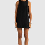 Woman wearing a black sleeveless dress on a white background