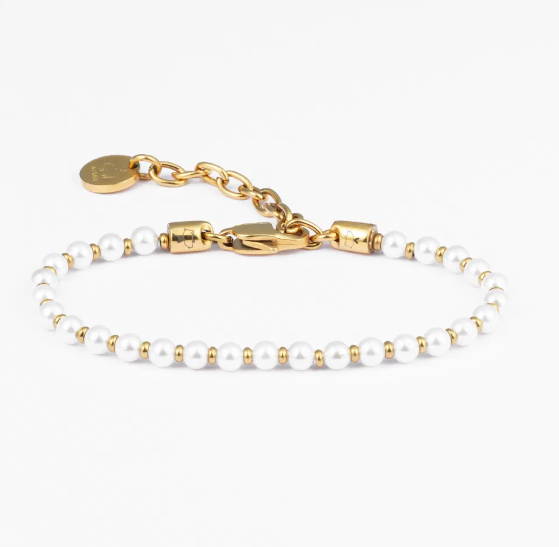 Gold and pearl bracelet on a white background