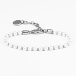 Silver bracelet with small pearls on a white background