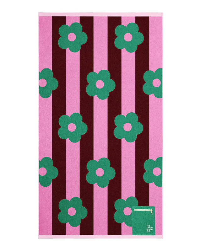 Towel with green floral patterns on pink and brown striped background