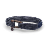 Navy braided bracelet with a bronze clasp on a white background