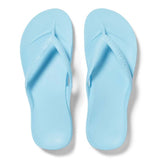 Pair of light blue flip-flops on a white background