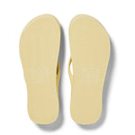 Pair of yellow flip-flops on a white background