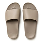 Pair of beige slides on a white background