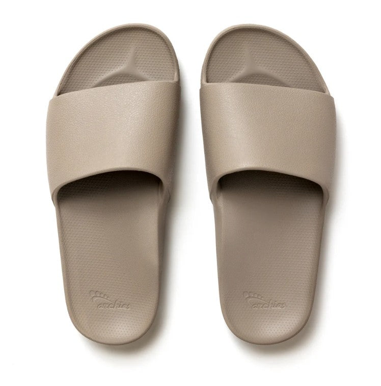 Pair of beige slides on a white background