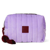 Purple quilted bag with a red tag on a white background