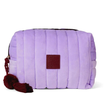Purple quilted bag with a red tag on a white background