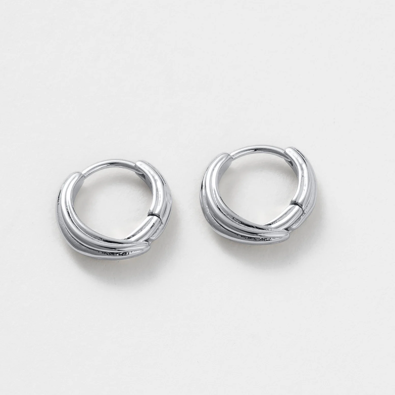 Pair of silver hoop earrings on a light gray background