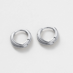 Pair of silver hoop earrings on a light gray background