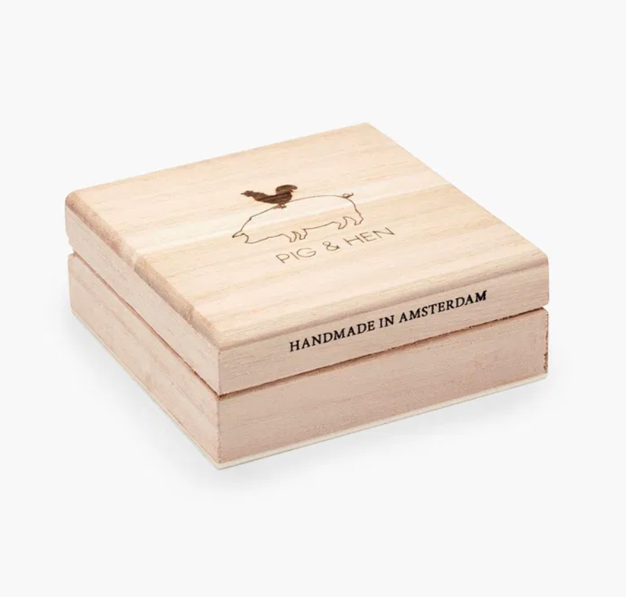 Wooden box with 'Pig & Hen' branding and 'Handmade in Amsterdam' text on a white background